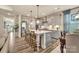 Well-lit kitchen featuring a large island, stainless steel appliances, and stylish gray cabinetry at 1497 Striped Bass Ln, Clover, SC 29710