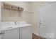 Practical laundry room with a washer, dryer, and shelving for ample storage space at 1497 Striped Bass Ln, Clover, SC 29710