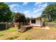Expansive backyard features a wooden deck, lush greenery, and ample space for outdoor activities at 1509 Wiltshire Rd, Salisbury, NC 21844