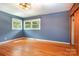 Bright bedroom with hardwood floors and windows allowing natural light to stream inside at 1509 Wiltshire Rd, Salisbury, NC 21844