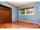 Bright bedroom with hardwood floors, a closet, and windows allowing natural light at 1509 Wiltshire Rd, Salisbury, NC 21844