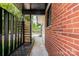 Inviting entryway showcases brick exterior and wooden accents, leading to a charming outdoor space at 1509 Wiltshire Rd, Salisbury, NC 21844