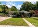 Charming single-story home with well-maintained lawn, mature trees, and attached garage at 1509 Wiltshire Rd, Salisbury, NC 21844