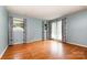 Bright living room features gleaming hardwood floors and natural light from three windows at 1509 Wiltshire Rd, Salisbury, NC 21844