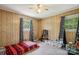 Cozy bedroom with wood paneling, blue curtains, and a ceiling fan at 1975 Peace Rd, Fort Mill, SC 29715