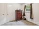 Bright bedroom with a window, chest of drawers and neutral-colored carpet at 1975 Peace Rd, Fort Mill, SC 29715