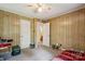 Bedroom featuring wood paneling and two doors, one leading to a bathroom at 1975 Peace Rd, Fort Mill, SC 29715