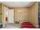 Cozy bedroom with wood paneling and adjacent bathroom access for added convenience and functionality at 1975 Peace Rd, Fort Mill, SC 29715
