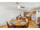 Bright dining area featuring a classic wooden table adjacent to the kitchen with a ceiling fan at 1975 Peace Rd, Fort Mill, SC 29715
