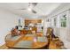 Open-concept dining area with a wooden table, connecting to the kitchen area with white appliances at 1975 Peace Rd, Fort Mill, SC 29715