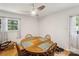 Bright dining room with a wooden table, a window view, and a ceiling fan at 1975 Peace Rd, Fort Mill, SC 29715