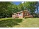 Charming brick home featuring a well-manicured lawn and verdant, mature landscaping at 1975 Peace Rd, Fort Mill, SC 29715