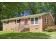 Charming brick ranch-style home with a well-maintained lawn and mature trees, offering curb appeal and a welcoming feel at 1975 Peace Rd, Fort Mill, SC 29715