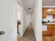 Hallway view leading from the kitchen, showing carpeted flooring and access to other rooms at 1975 Peace Rd, Fort Mill, SC 29715
