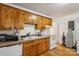 Functional kitchen with classic wooden cabinets, modern appliances, and easy access to laundry room at 1975 Peace Rd, Fort Mill, SC 29715