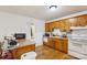 Functional kitchen featuring wooden cabinets, white appliances, and a peninsula counter for casual dining at 1975 Peace Rd, Fort Mill, SC 29715