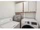 Efficient laundry room with modern appliances, cabinet storage, and a water heater at 1975 Peace Rd, Fort Mill, SC 29715