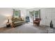 Cozy living room with neutral carpet, large windows providing natural light, and comfortable seating arrangements at 1975 Peace Rd, Fort Mill, SC 29715