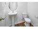 Bathroom featuring a pedestal sink, wood-look floors, and a toilet at 207 Giant Oak Ave, Statesville, NC 28677