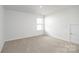 Bedroom featuring neutral carpet, white walls, and a window at 207 Giant Oak Ave, Statesville, NC 28677