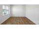 Bright bedroom with hardwood floors and natural light from a large window at 207 Giant Oak Ave, Statesville, NC 28677