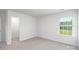 Bright bedroom featuring neutral carpet, walk-in closet, and a window at 207 Giant Oak Ave, Statesville, NC 28677