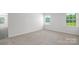 A bright bedroom with neutral carpet and multiple windows at 207 Giant Oak Ave, Statesville, NC 28677