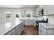 Modern kitchen featuring granite countertops, white cabinets, and stainless steel appliances at 207 Giant Oak Ave, Statesville, NC 28677