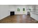 Open-concept living room and kitchen featuring a fireplace and hardwood floors at 207 Giant Oak Ave, Statesville, NC 28677