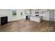Open-concept living room and kitchen with hardwood floors and a fireplace at 207 Giant Oak Ave, Statesville, NC 28677