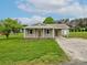 Charming single-story home with a covered front porch, attached carport, and well-maintained lawn at 210 Stonefield Ln, Salisbury, NC 28146