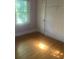 Bedroom featuring hardwood floors and closet space, providing a cozy and functional living area at 215 S Belvedere Ave, Gastonia, NC 28054