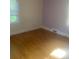 Bright bedroom with hardwood floors and natural light, creating a serene and comfortable space at 215 S Belvedere Ave, Gastonia, NC 28054