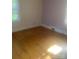Bedroom with hardwood floors and natural light, offering a simple, comfortable space at 215 S Belvedere Ave, Gastonia, NC 28054