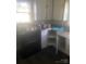 Kitchen features white cabinets and countertops, offering a functional space with potential for customization at 215 S Belvedere Ave, Gastonia, NC 28054