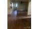 Open-concept living room with gleaming hardwood floors, offering a spacious and inviting atmosphere at 215 S Belvedere Ave, Gastonia, NC 28054