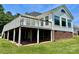 Back exterior view of a home with a large wooden deck and brick foundation at 2547 Bill Thompson Rd, Lancaster, SC 29720