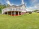 The backyard features a large deck, brick foundation, and spacious lawn at 2547 Bill Thompson Rd, Lancaster, SC 29720