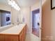 A pristine bathroom features a long vanity with dual sinks, and lovely fixtures, along with an entrance to the bedroom at 2547 Bill Thompson Rd, Lancaster, SC 29720