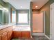 An exceptional bathroom features a tub, a glass shower, a sink with beautiful fixtures, and a large window at 2547 Bill Thompson Rd, Lancaster, SC 29720