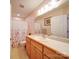 Well-maintained bathroom includes sink vanity, toilet, shower, and a floral curtain at 2547 Bill Thompson Rd, Lancaster, SC 29720