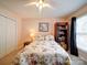 An exceptionally bright bedroom boasts a ceiling fan, a floral bedspread, a bookshelf, and a side table at 2547 Bill Thompson Rd, Lancaster, SC 29720