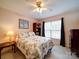 Cozy bedroom with floral comforter, ceiling fan, and natural light from the window at 2547 Bill Thompson Rd, Lancaster, SC 29720