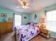 A bright bedroom features a ceiling fan, matching curtains and bedding, carpet, and a chest of drawers at 2547 Bill Thompson Rd, Lancaster, SC 29720