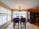 Bright dining area featuring a chandelier, large windows, and an adjacent modern kitchen with stainless steel appliances at 2547 Bill Thompson Rd, Lancaster, SC 29720