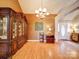 Well-lit entryway featuring hardwood floors, a chandelier, and decorative furniture at 2547 Bill Thompson Rd, Lancaster, SC 29720