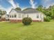 The rear exterior has white siding and a well-manicured lawn with mature trees at 2547 Bill Thompson Rd, Lancaster, SC 29720