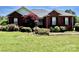 Charming brick home with beautiful landscaping, including lush greenery and a vibrant red maple tree at 2547 Bill Thompson Rd, Lancaster, SC 29720