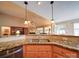 Kitchen featuring granite countertops and a stainless steel dishwasher, open to the living area with vaulted ceilings at 2547 Bill Thompson Rd, Lancaster, SC 29720