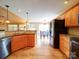 Well-lit kitchen boasts granite countertops, stainless steel appliances, and warm wood cabinetry at 2547 Bill Thompson Rd, Lancaster, SC 29720